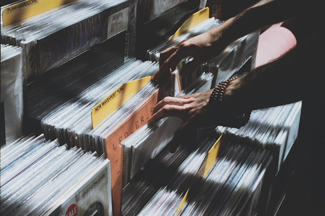 A person browsing through vinyls in a record store