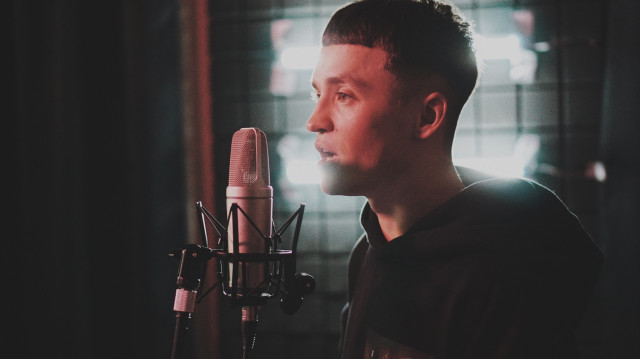 Man recording vocals in the studio