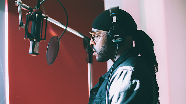 Male singing on a mic in the studio