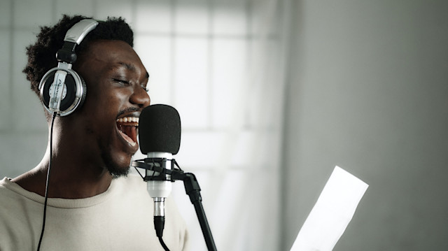 Man recording vocals over a mic