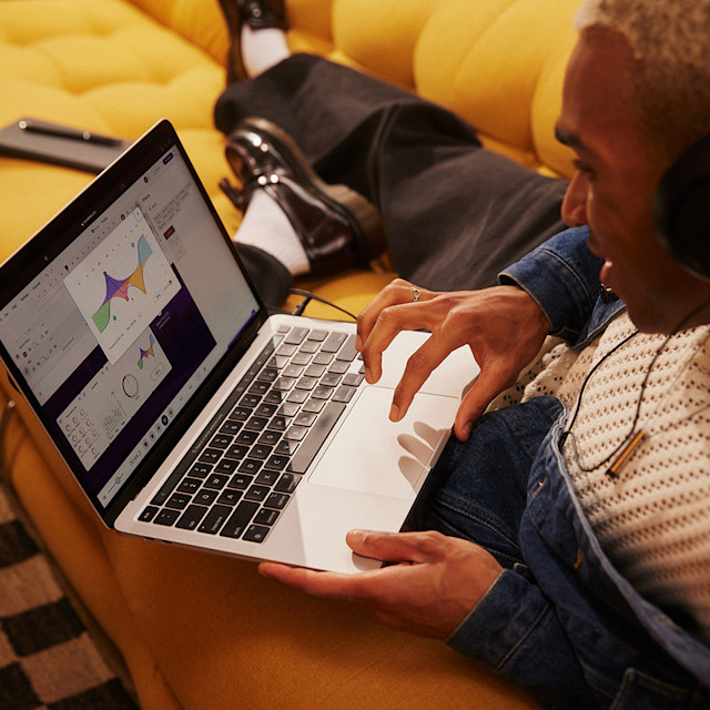 A man on couch using EQ effect in Soundtrap