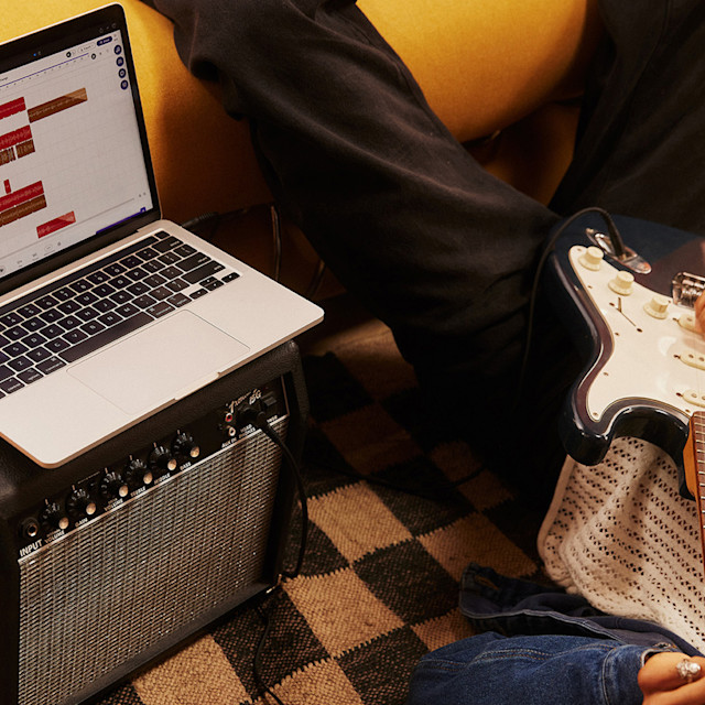 A guitarist recording his audio in Soundtrap