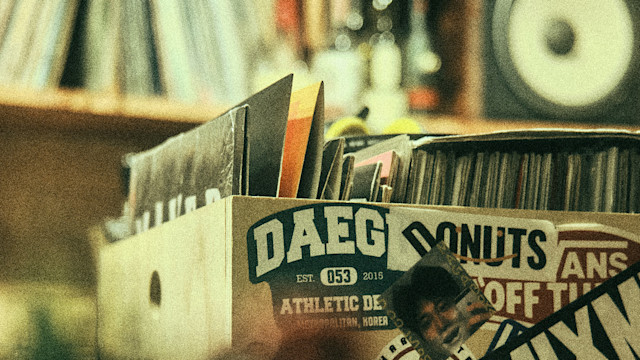 A crate with vinyl LPs and stickers on it