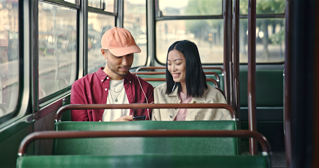 Man and woman listening to music inside a tram
