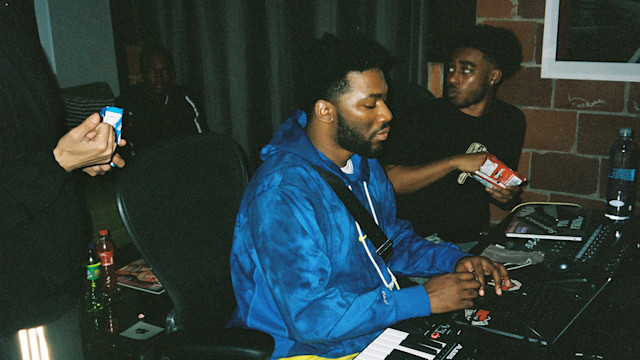 Trap producers and artists in a dark studio snacking on doritos.