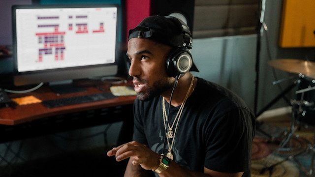 Man listening to a mix though a headphone in the studio