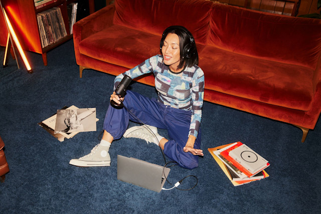 Woman recording vocals in a laptop