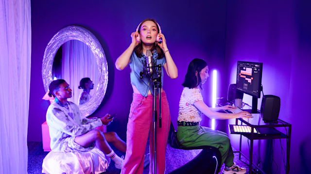 Woman recording vocals with friends