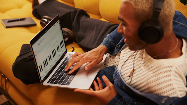 Man mixing music in Soundtrap while on the couch