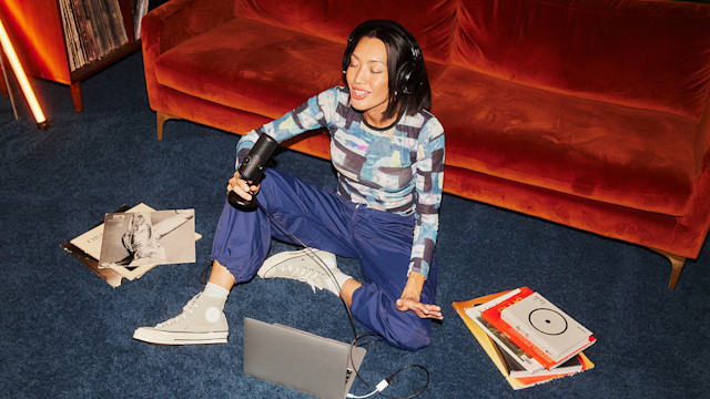 Girl on the floor singing into usb mic