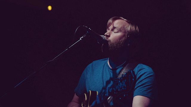 Man singing over a mic