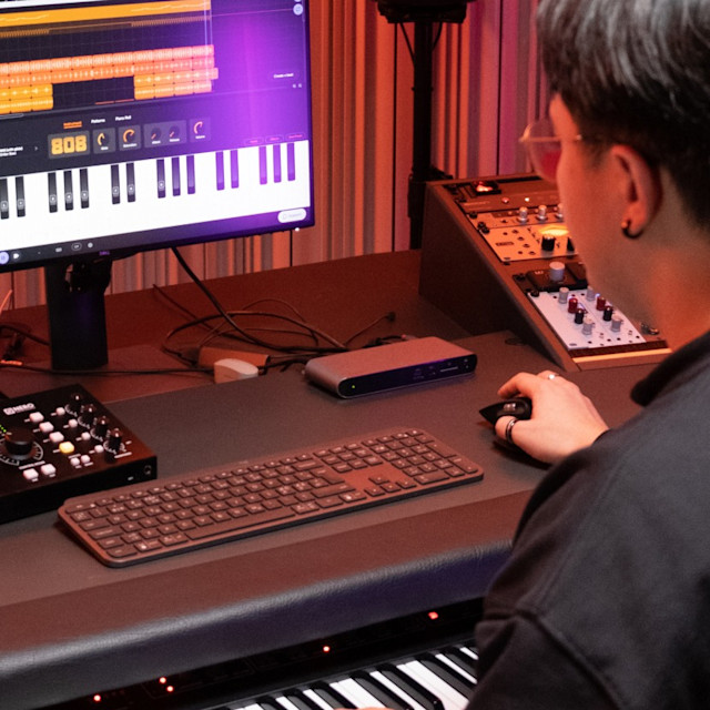 A musician in the studio producing with 808 with glide