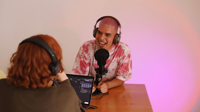 Two people recording a podcast using Soundtrap at a table.