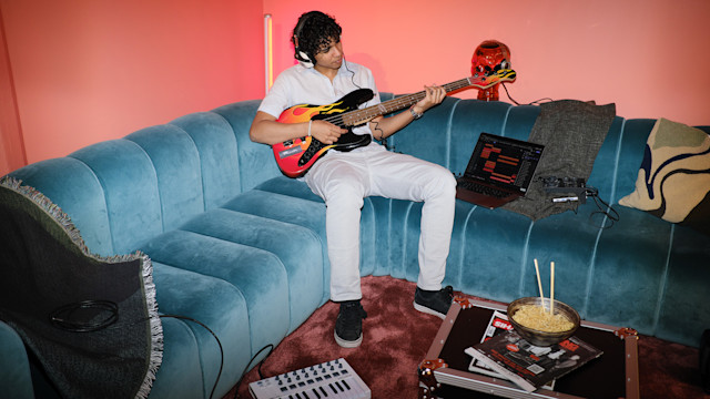 Man playing bass on couch