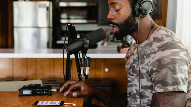 Male singer recording vocals on a mobile device