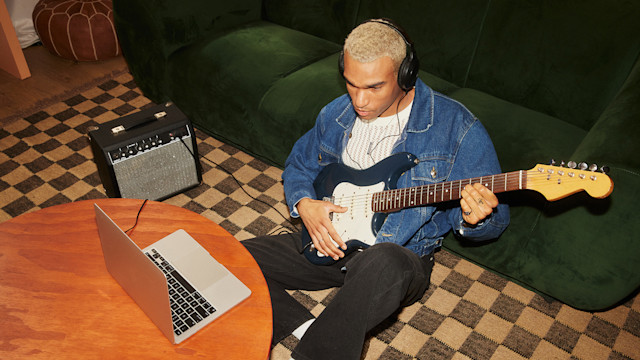 Man creating music playing the guitar