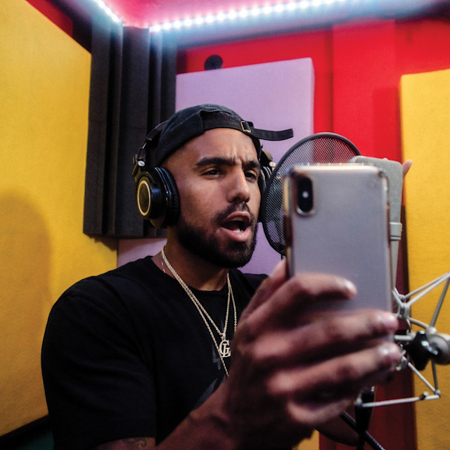 Vocalist in studio recording lyrics