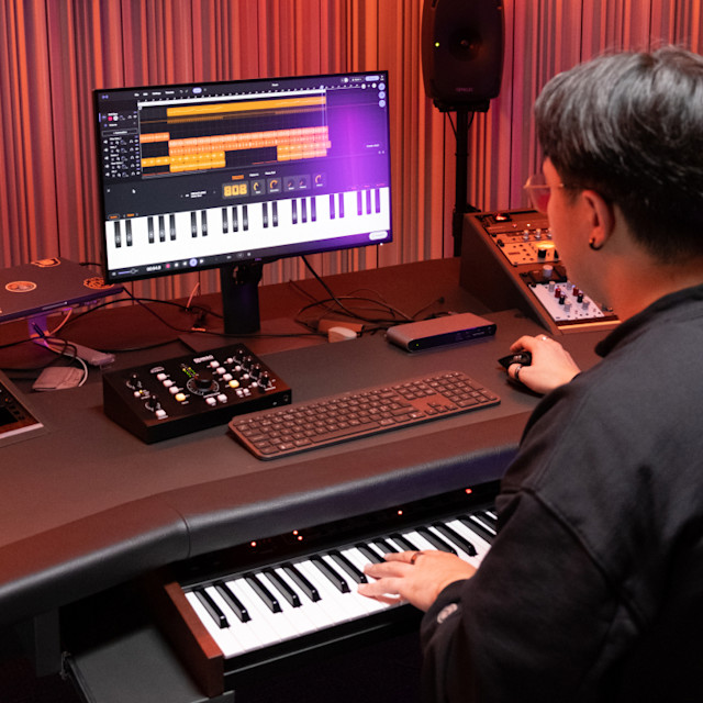 Male musician in studio playing 808 with glide