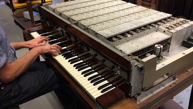 A man playing the Novachord synthesizer