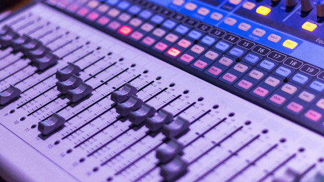 An audio mixing board in a studio