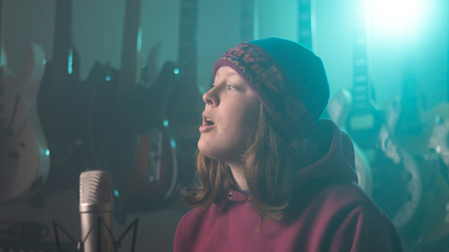 Girl singing over a mic