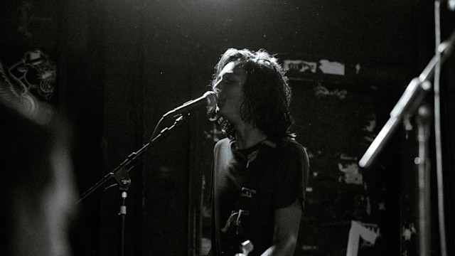 Male singer singing over a mic