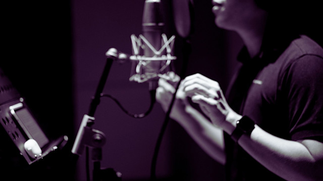 Man recording vocals in the studio