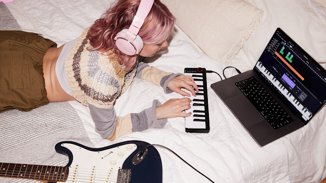 Girl making music on bed
