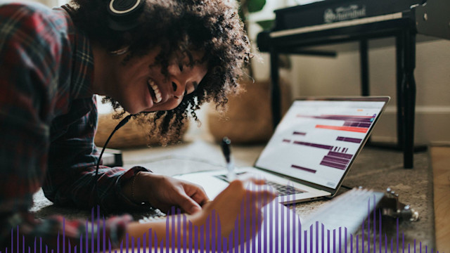 Woman wearing headset writing a song